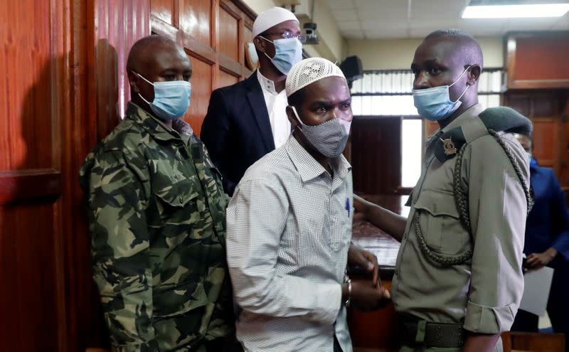 Hussein Hassan and Mohamed Ahmed, suspects charged with helping al Qaeda-linked militants to launch an attack on the Westgate mall, leave the dock before being sentenced, at the Milimani Law Courts in Nairobi