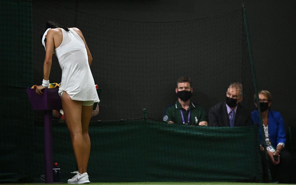 Emma Raducanu takes a moment during the match - AFP