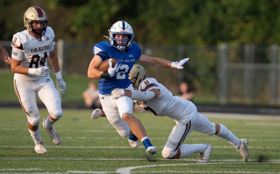 Brebeuf Jesuit Braves’ Dylan Wells unsuccessfully tries to take down Bishop Chatard Trojans’ Riley Kinnett during the game between Brebeuf Jesuit Braves and Bishop Chatard Trojans on Friday, Aug. 18, 2023, at Bishop Chatard High School in Indianapolis.