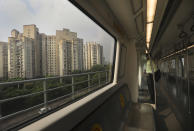 Commuters travel in an almost empty Delhi metro train in New Delhi, India, Monday, Sept. 7, 2020. India's coronavirus cases are now the second-highest in the world and only behind the United States, as the caseload crosses Brazil on a day when urban metro trains partially resume service in the capital New Delhi and other states. (AP Photo/Manish Swarup)