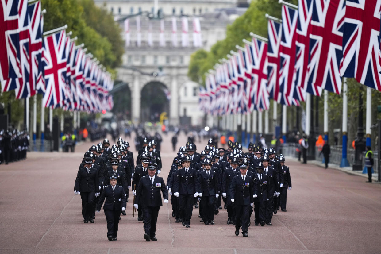 Police officers take positions ahead of the Queen Elizabeth II funeral in central London, Monday, Sept. 19, 2022. The Queen, who died aged 96 on Sept. 8, will be buried at Windsor alongside her late husband, Prince Philip, who died last year. (AP Photo/Vadim Ghirda, Pool)