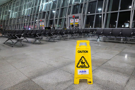 A safety sign is seen in an empty section of the arrivals area of Terminal 4 following a water main break that closed part of the terminal at John F. Kennedy International Airport in New York City, U.S. January 7, 2018. REUTERS/Andrew Kelly