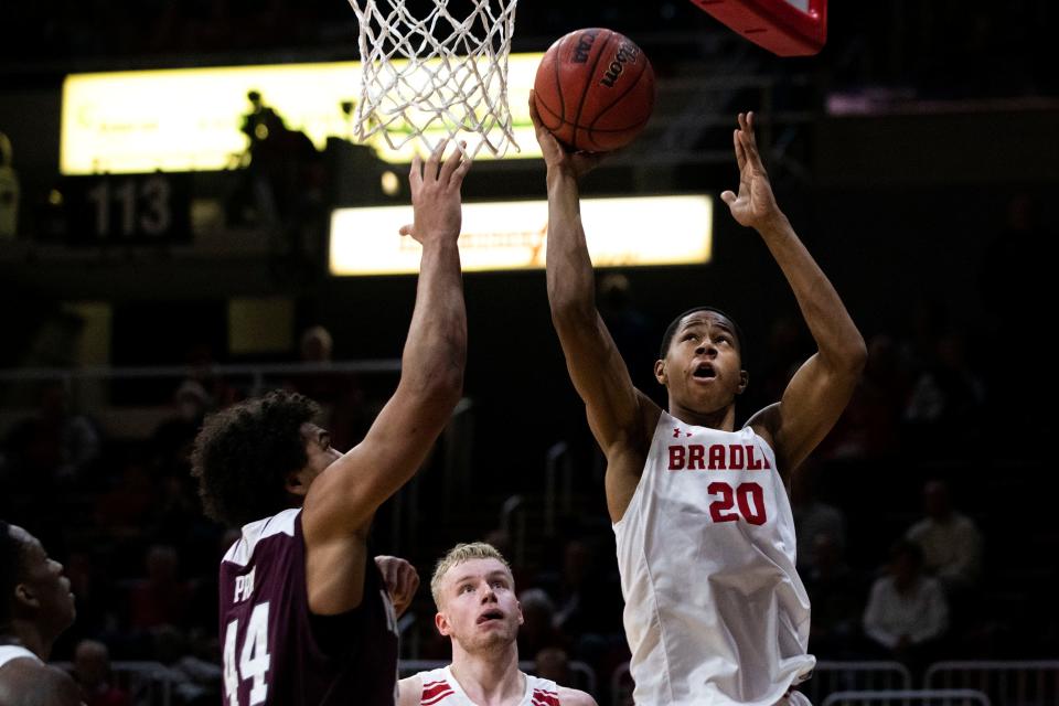 Bradley's Jayson Kent jumps for a layup as Missouri State's Gaige Prim tries to block him during the Missouri Valley Conference game in Carver Arena on Jan. 5, 2022. The Bears beat the Braves 71-69 with a buzzer beating 3-point shot.