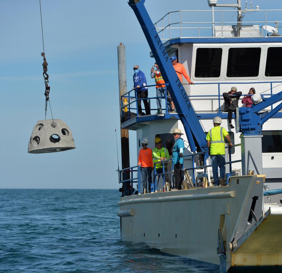 Crew members from Reef Innovations lower a memorial pet reef ball at the M2 artificial reef site offshore of Sarasota on Wednesday, Jan. 18, 2023. 