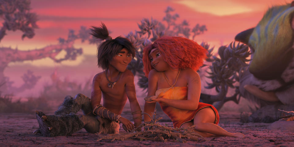 This image released by DreamWorks shows Guy, voiced by Ryan Reynolds, left, and Eep Crood, voiced by Emma Stone, in a scene from the animated film "The Croods: A New Age." (DreamWorks Animation via AP)