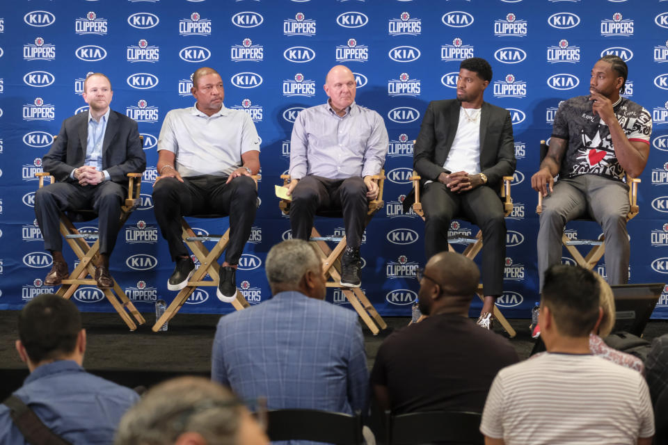 From left, Los Angeles Clippers President of Basketball Operations Lawrence Frank, head coach Doc Rivers, team chairman Steve Ballmer, Paul George and Kawhi Leonard attend a press conference in Los Angeles, Wednesday, July 24, 2019. Nearly three weeks after the native Southern California superstars shook up the NBA by teaming up with the Los Angeles Clippers, the dynamic duo makes its first public appearance. (AP Photo/Ringo H.W. Chiu)