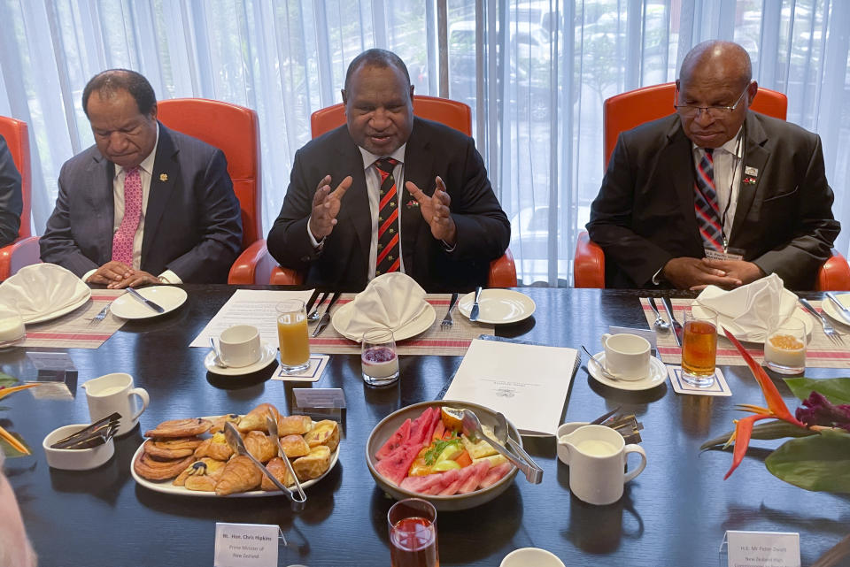 Papua New Guinea Prime Minister James Marape, center, gestures to New Zealand Prime Minister Chris Hipkins at a meeting ahead of the United States - Pacific Summit in Port Moresby, Papua New Guinea, Monday, May 22, 2023. The United States is scheduled to sign a new security pact with Papua New Guinea on Monday as the U.S. continues to jostle with China for influence in the Pacific. (AP Photo/Nick Perry)