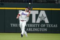 Texas Rangers left fielder DJ Peters reaches up to catch a fly out by Los Angeles Angels' Jared Walsh in the sixth inning of a baseball game in Arlington, Texas, Tuesday, Sept. 28, 2021. (AP Photo/Tony Gutierrez)