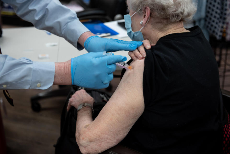 A pharmacist administers a dose of the Covid-19 vaccine in Mountain Brook, Alabama.