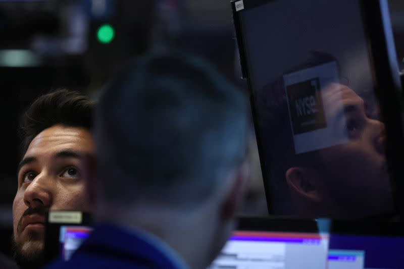 Traders work on the floor of the NYSE in New York