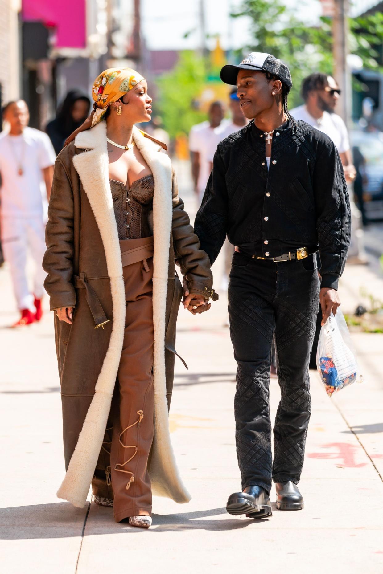 Rihanna and A$AP Rocky walk hand in hand while on set in the Bronx on July 10, 2021, in New York City.