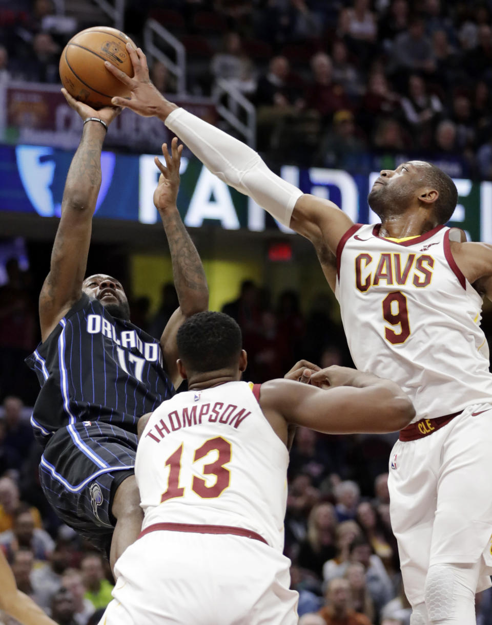 Cleveland Cavaliers’ Dwyane Wade (9) blocks a shot by Orlando Magic’s Jonathon Simmons (17) as Tristan Thompson (13) defends during the second half of an NBA basketball game Thursday, Jan. 18, 2018, in Cleveland. The Cavaliers won 104-103. (AP Photo/Tony Dejak)