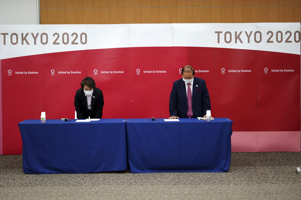 Seiko Hashimoto, left, President of the Tokyo 2020 Organizing Committee of the Olympic and Paralympic Games (Tokyo 2020), and Toshiro Muto, CEO of Tokyo 2020, bow at the beginning of a news conference Thursday, March 11, 2021, following the International Olympic Committee (IOC) general meeting. (AP Photo/Eugene Hoshiko, Pool)