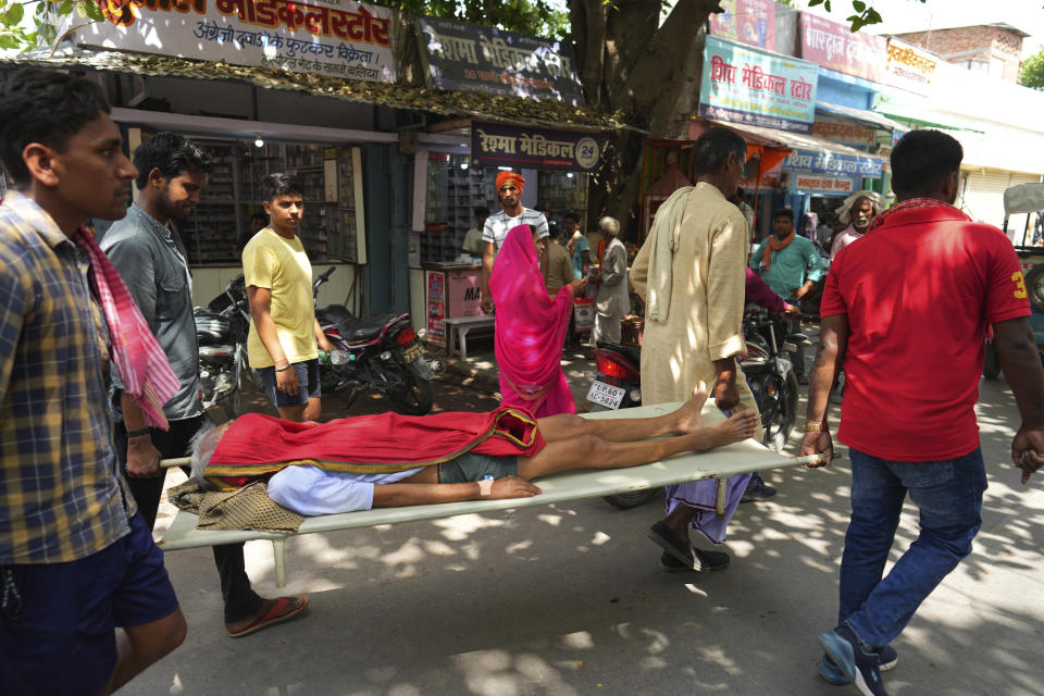 An elderly person suffering from heat related ailment is carried on a stretcher to the government district hospital in Ballia, Uttar Pradesh state, India, Monday, June 19, 2023. Several people have died in two of India's most populous states in recent days amid a searing heat wave, as hospitals find themselves overwhelmed with patients. More than hundred people in the Uttar Pradesh and dozens in neighboring Bihar have died due to heat-related illness. (AP Photo/Rajesh Kumar Singh)