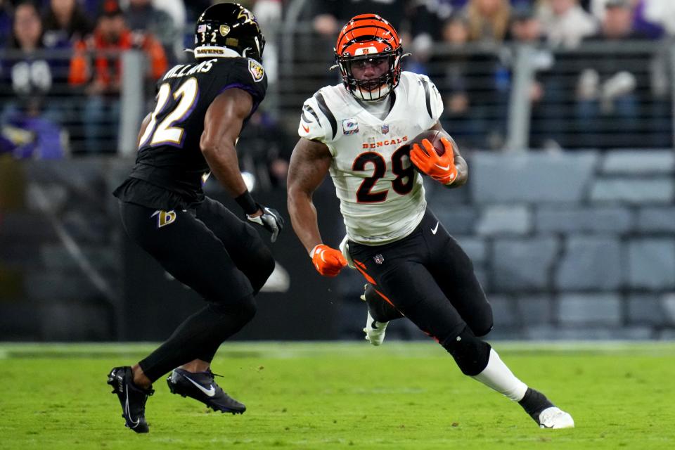 Cincinnati Bengals running back Joe Mixon carries the ball and runs at Ravens safety Marcus Williams. Over the last two weeks, Mixon has been better at breaking through the opposing team's defensive line.