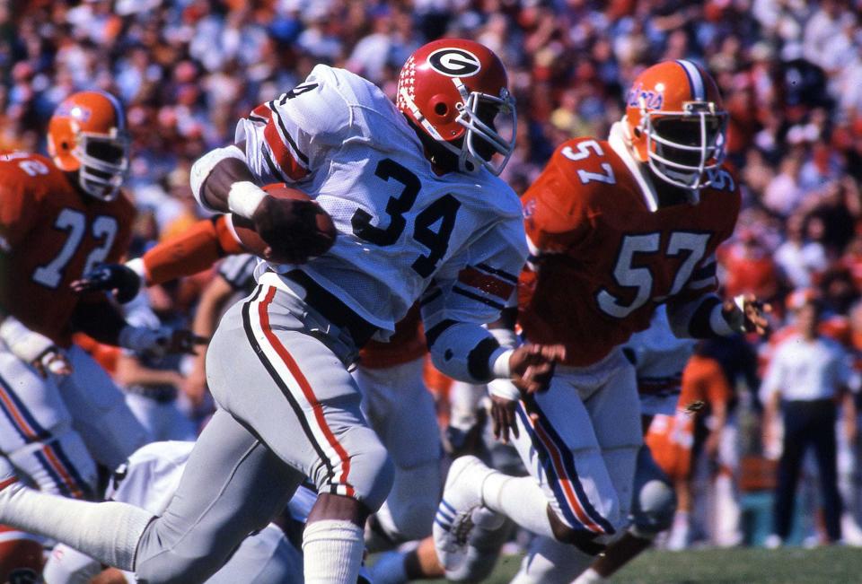 Georgia running back Herschel Walker (34) ran for 238 yards against Florida in 1980, but his heroic effort was overshadowed by a 93-yard touchdown pass from Buck Belue to Lindsay Scott that remains one of the most iconic plays in college football history. (Times-Union file photo)