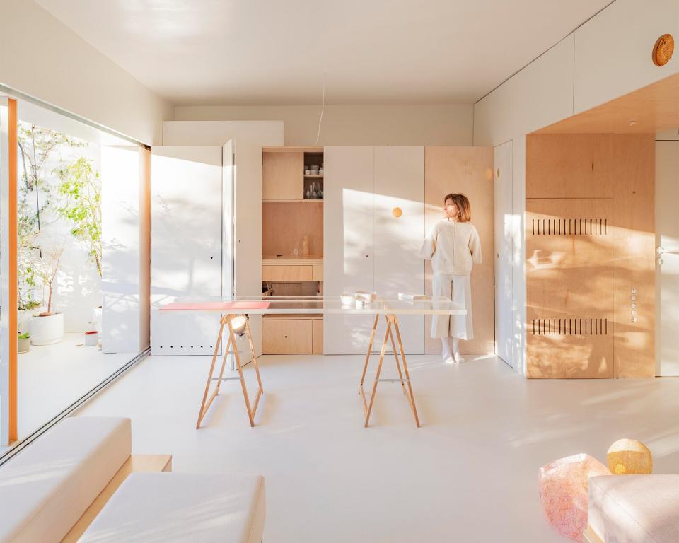 A family of architects teamed up to bring sunshine to every corner of their 650-square-foot flat in Madrid.