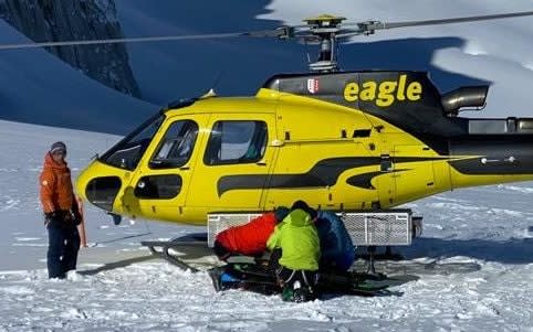 Adam George heliskiing with clients, taken prior to the accident