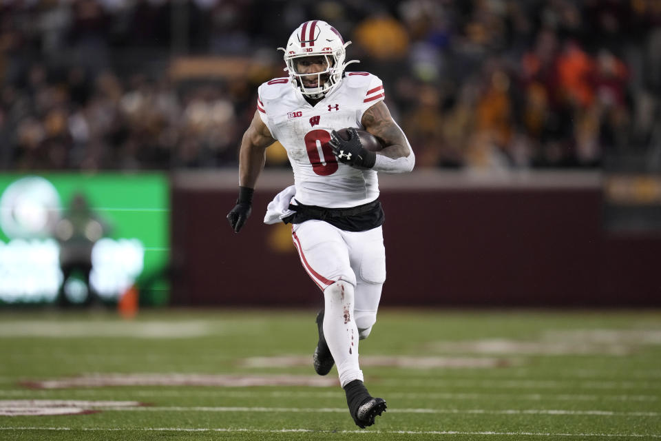 Wisconsin running back Braelon Allen (0) runs with the football during the second half of an NCAA college football game against Minnesota, Saturday, Nov. 25, 2023, in Minneapolis. (AP Photo/Abbie Parr)