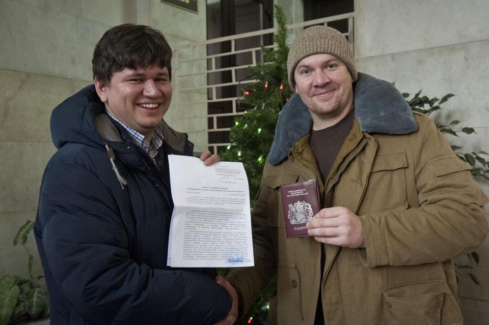 Greenpeace handout shows Greenpeace International activist Perrett posing with his lawyer Golubok after criminal case against him was dropped, in Saint Petersburg