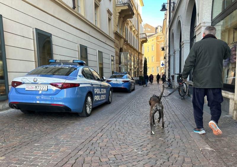 A dog owner walks in pet in Bolzano, the capital of Italy's largely German-speaking South Tyrol region. Christoph Sator/dpa