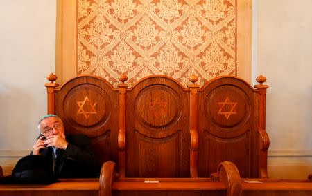 A Jewish visitor speaks on his phone in the synagogue in the village of Mad, Hungary, July 21, 2016. Picture taken July 21, 2016. REUTERS/Laszlo Balogh