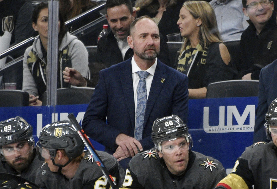 FILE -Vegas Golden Knights coach Pete DeBoer looks on from the bench against the Carolina Hurricanes during the first period of an NHL hockey game Saturday, Feb. 8, 2020, in Las Vegas. Pete DeBoer is very familiar with the Vegas Golden Knights and their playoff history. The coach is about to become a part of all six of that franchise's postseason appearances, either on their bench or against them. (AP Photo/David Becker, File)