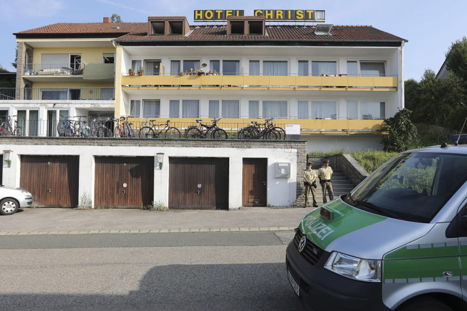<p>Police officers secure a former hotel where a Syrian man lived before the explosion in Ansbach, Germany, Monday, July 25, 2016. (AP Photo/Matthias Schrader)</p>