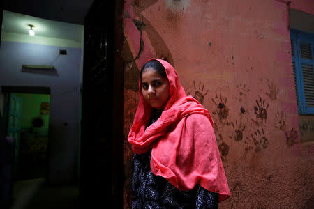 Nada Salah, 14, looks on outside her home in Alwasata village of Assiut Governorate, south of Cairo, Egypt, February 8, 2018. REUTERS/Hayam Adel/Files