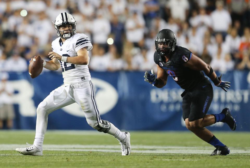 BYU quarterback Tanner Mangum sprints away from Boise State defensive lineman during game against Boise State on Saturday, Sept. 12, 2015, at LaVell Edwards Stadium in Provo. | Scott G Winterton, Deseret News