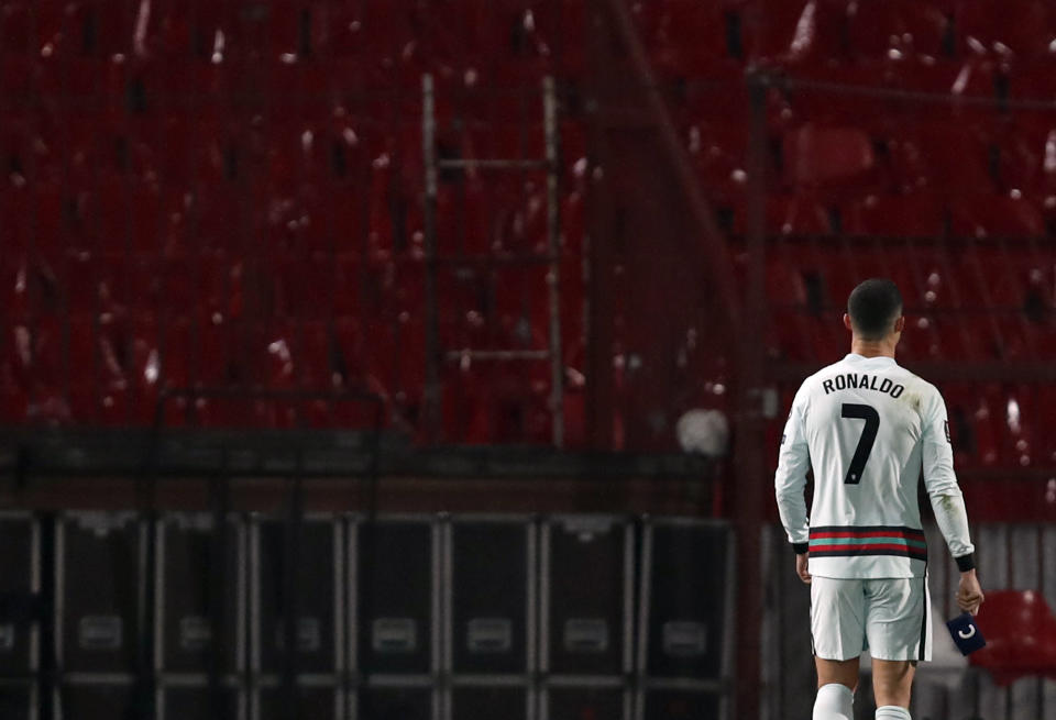 Portugal's Cristiano Ronaldo holds his captain's armband, right, as he reacts during the World Cup 2022 group A qualifying soccer match against Serbia, at the Rajko Mitic stadium in Belgrade, Serbia, Saturday, March 27, 2021. The captain’s armband which Cristiano Ronaldo threw to the pitch after his overtime winning goal was disallowed in a World Cup qualifier against Serbia has been put on auction Tuesday March 30, 2021. The armband is being auctioned by a charity group raising money for surgery of a six-month-old boy from Serbia suffering spinal muscular atrophy. (AP Photo/Darko Vojinovic)