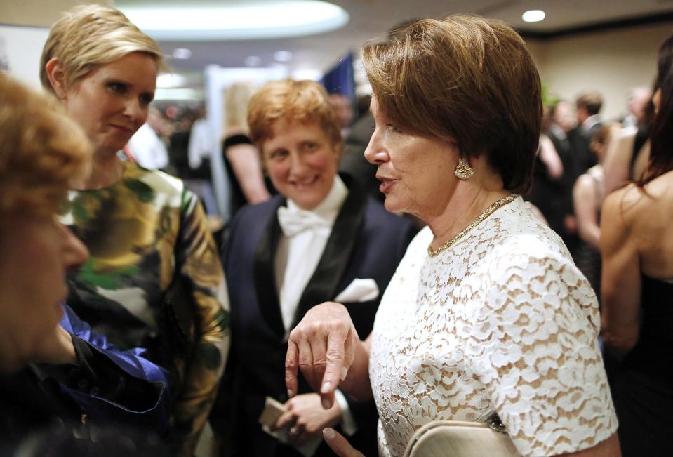 U.S. House Minority Leader Nancy Pelosi (D-CA) (R) talks to a group, including actress Cynthia Nixon (2nd L), as they arrive at the annual White House Correspondents' Association Dinner in Washington May 3, 2014. REUTERS/Jonathan Ernst REUTERS/Jonathan Ernst