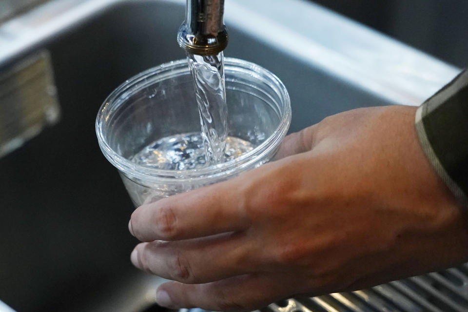 FILE - A cup of water is drawn from a faucet at Johnny T's Bistro and Blues in Jackson, Miss., on Thursday, Sept. 1, 2022. The EPA said Monday, May 6, 2024, that it found “insufficient evidence” that racial discrimination shaped decisions made by two Mississippi agencies about water system funding for the majority-Black city of Jackson. (AP Photo/Rogelio V. Solis, File)