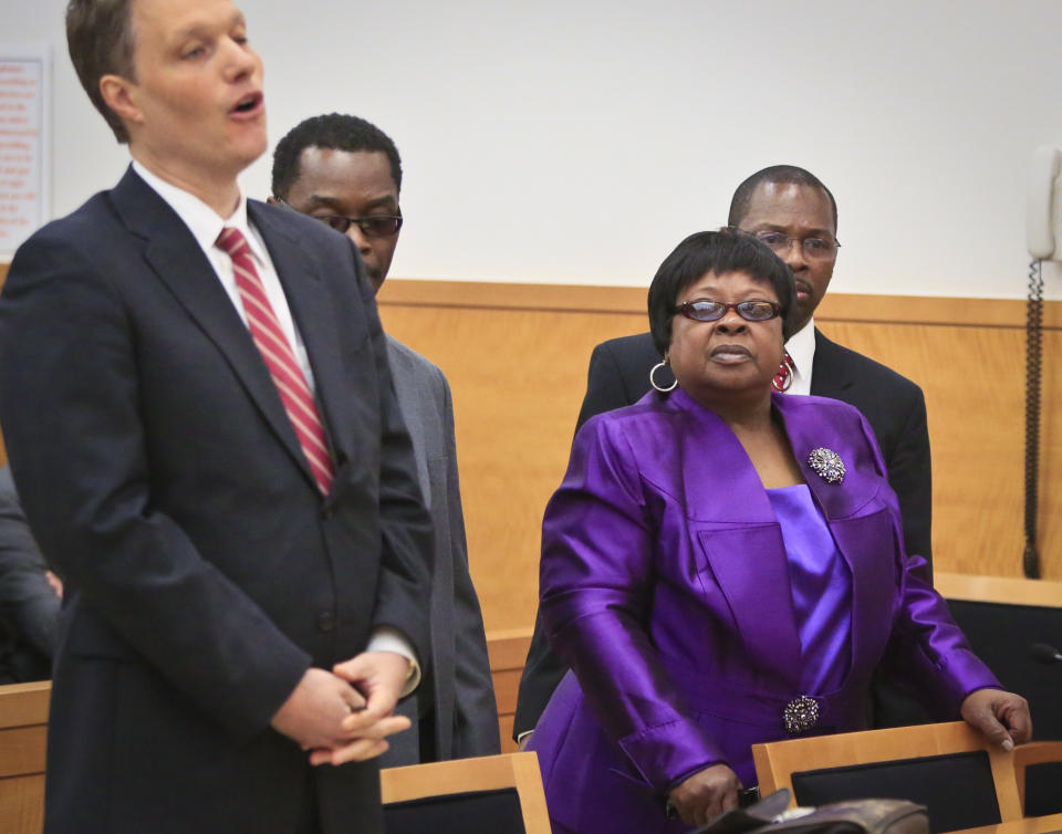 Loiuse Austin, second from right, and her sons Alvena Jennette, second from left, and Neter Kamani, far right, listens as Attorney Pierre Sussman speaks during an exoneration hearing at Brooklyn Supreme Court, Tuesday May 6, 2014 in New York. Judge Neil Firetog threw out a decades-old conviction of three half-brothers Jennette, Robert Hill and Darryl Austin because of questionable tactics by the investigating homicide detective Louis Scarcella. Louise Austin stood for son Darryl who died in prison. (AP Photo/Bebeto Matthews)