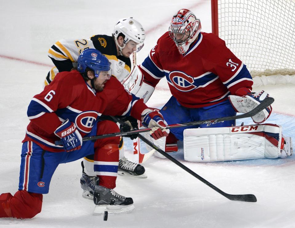 Montreal Canadiens defenseman Douglas Murray (6) and Boston Bruins Matt Frasier battle for the puck in front of Canadiens goalie Carey Price during the first period in Game 4 in the second round of the NHL Stanley Cup playoffs Thursday, May 8, 2014, in Montreal. (AP Photo/The Canadian Press, Ryan Remiorz)