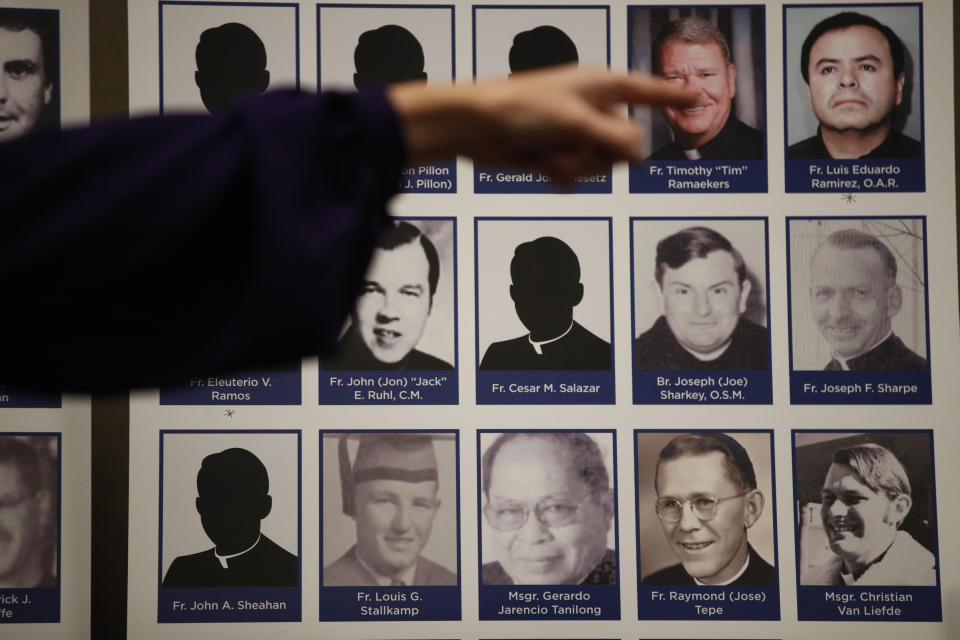 An advocate and survivor of sexual abuse, points to the photos of Catholic priests accused of sexual misconduct by victims during a news conference Thursday, Dec. 6, 2018, in Orange, Calif. Lawyer Mike Reck on Thursday said that's many more than those reported by the Diocese and demanded greater transparency. The Diocese of Orange says the lawyers are trying to re-litigate old claims that the church takes any accusations of abuse "extraordinarily seriously." (AP Photo/Jae C. Hong)
