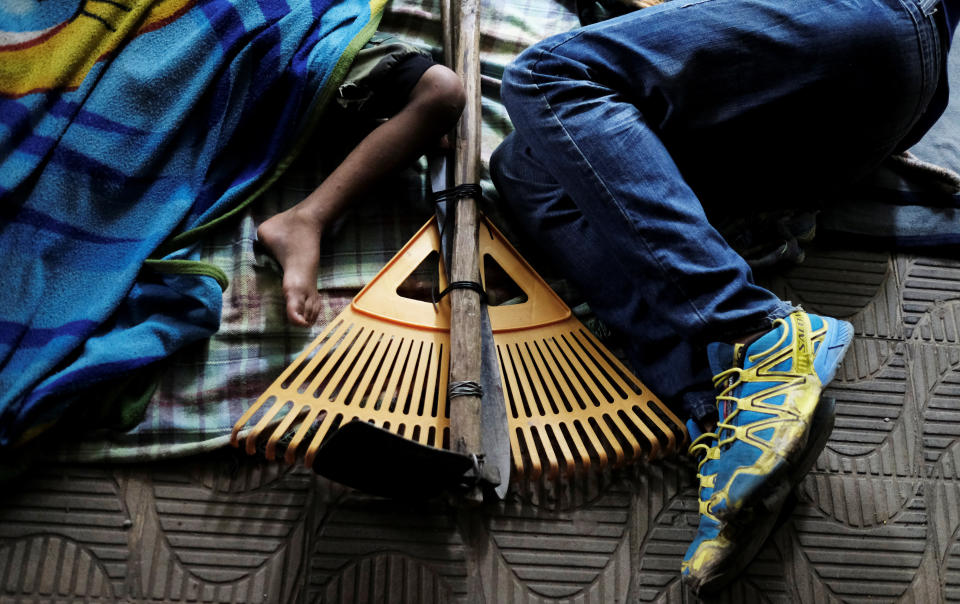 <p>A Venezuelan man and his son sleep along a street as they wait to show their passports or identity cards the next day, at the Pacaraima border control, Roraima state, Brazil, Aug. 8, 2018. (Photo: Nacho Doce/Reuters) </p>