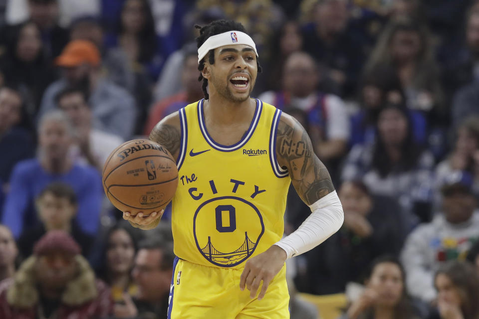 Golden State Warriors guard D'Angelo Russell dribbles upcourt against the Phoenix Suns during the first half of an NBA basketball game in San Francisco, Friday, Dec. 27, 2019. (AP Photo/Jeff Chiu)