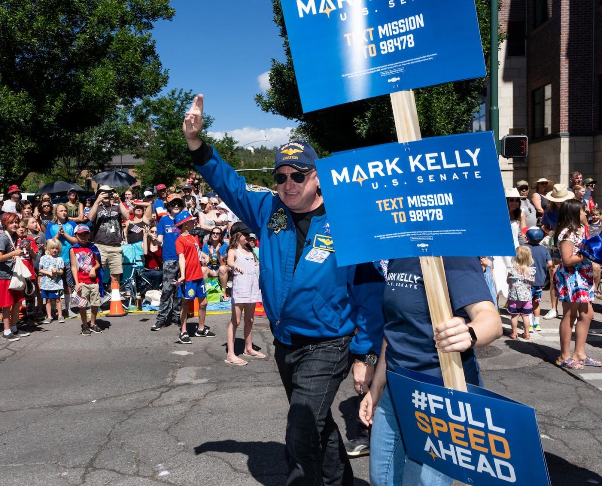 Democratic U.S. Sen. Mark Kelly of Arizona marches in a Fourth of July parade in Arizona on July 4, 2022. <a href="https://www.gettyimages.com/detail/news-photo/sen-mark-kelly-d-ariz-marches-in-the-flagstaff-chamber-of-news-photo/1241705786?adppopup=true" rel="nofollow noopener" target="_blank" data-ylk="slk:Bill Clark/CQ-Roll Call, Inc via Getty Images;elm:context_link;itc:0;sec:content-canvas" class="link ">Bill Clark/CQ-Roll Call, Inc via Getty Images</a>