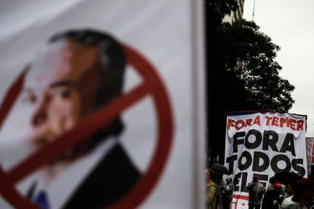 Demonstrators hold a sign reading "Out Temer" during a protest against Brazil's President Michel Temer in Sao Paulo, Brazil, May 21, 2017. REUTERS/Nacho Doce