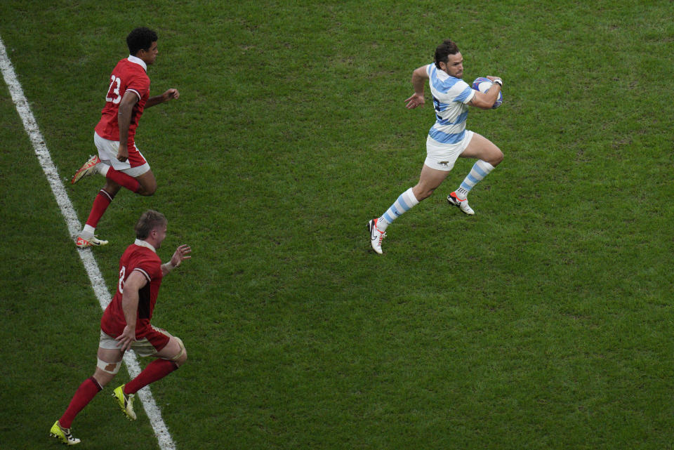 Argentina's Nicolas Sanchez sprints to score a try during the Rugby World Cup quarterfinal match between Wales and Argentina at the Stade de Marseille in Marseille, France, Saturday, Oct. 14, 2023. (AP Photo/Daniel Cole)