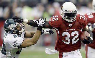 Arizona running back Edgerrin James (32) stiff arms Philadelphia safety Quintin Demps on a first-half run in Sunday’s NFC Championship in Glendale, Ariz.David J. Phillip | Associated Press