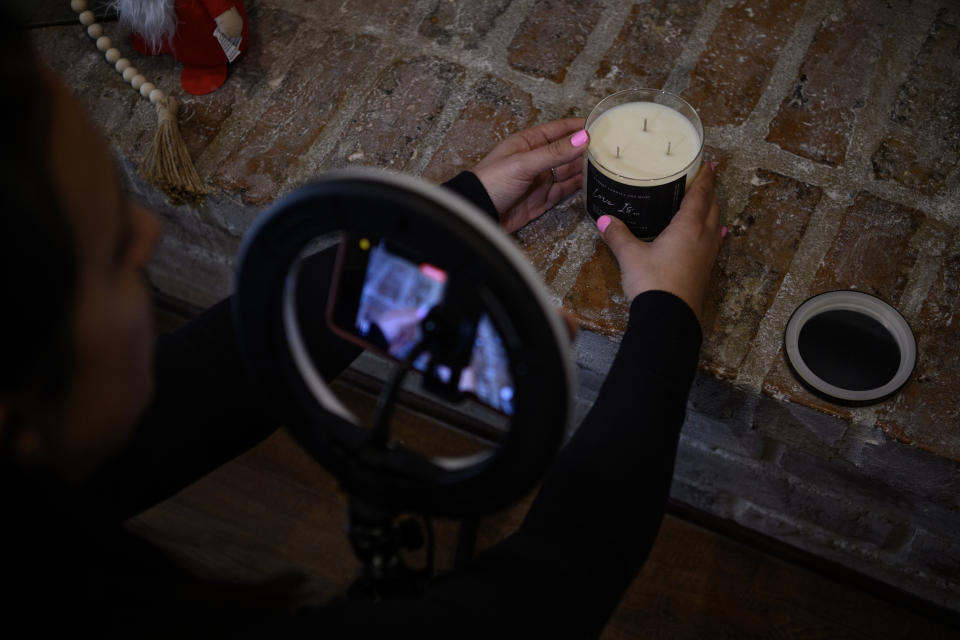 Kuehne creates a video reviewing a candle at her home. (Callaghan O'Hare for The Washington Post)