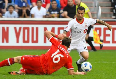 Jul 21, 2018; Chicago, IL, USA; Toronto FC forward Sebastian Giovinco (10) attempts to shoot the ball against Chicago Fire defender Jonathan Campbell (16) during the second half at Bridgeview Stadium. Mandatory Credit: Mike DiNovo-USA TODAY Sports