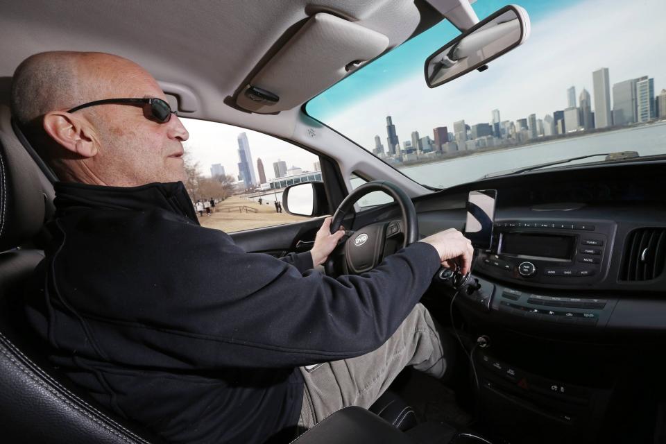 Uber driver Glen Snower sits in a BYD e6 electric car in Chicago, Illinois March 18, 2015. (REUTERS/Jim Young)