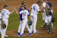 The Los Angeles Dodgers celebrate after a 7-0 win over the Miami Marlins in a baseball game Saturday, May 15, 2021, in Los Angeles. (AP Photo/Ashley Landis)