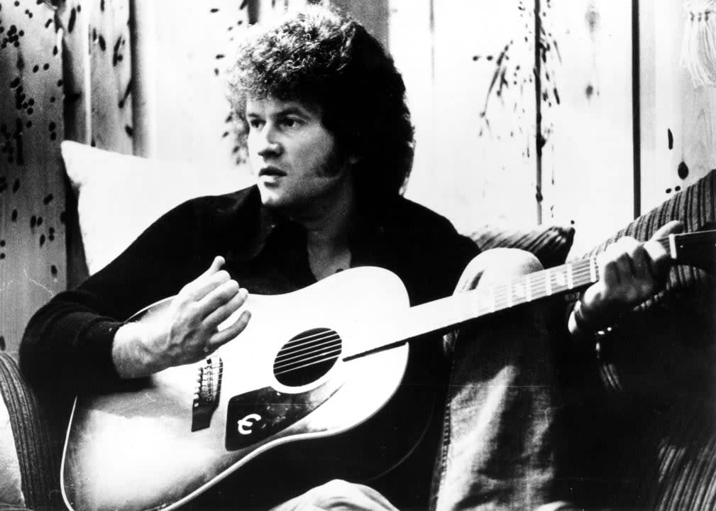 Terry Jacks sitting wit guitar.