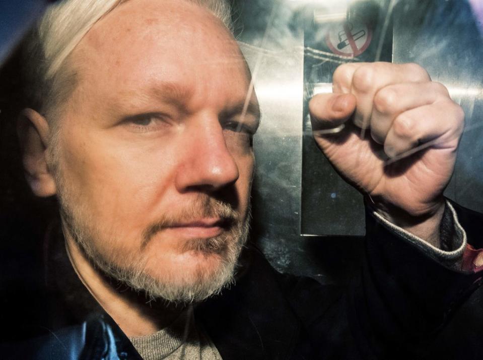 WikiLeaks founder Julian Assange gestures from the window of a prison van as he is driven into Southwark Crown Court in London on May 1 2019, before being sentenced to 50 weeks in prison for breaching his bail conditions in 2012.<span class="copyright">Daniel Leal-Olivas—AFP/Getty Images</span>