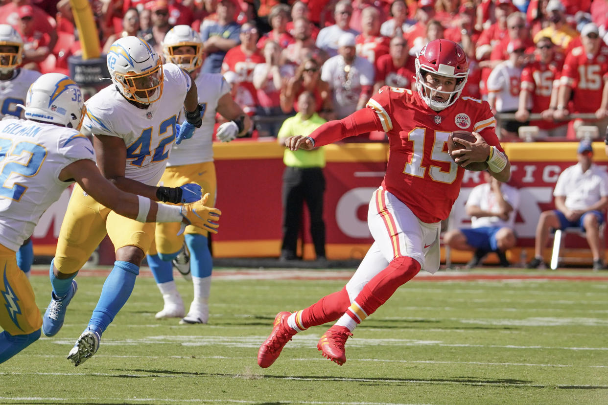 Sep 26, 2021; Kansas City, Missouri, USA; Kansas City Chiefs quarterback Patrick Mahomes (15) runs the ball as Los Angeles Chargers safety Alohi Gilman (32) defends during the game at GEHA Field at Arrowhead Stadium. Mandatory Credit: Denny Medley-USA TODAY Sports Amazon Prime