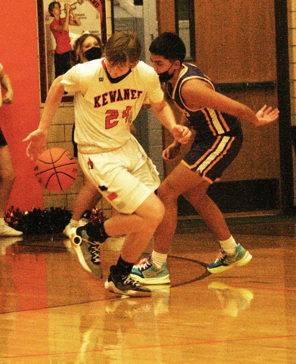 Kewanee's Brady Clark swipes the ball from a Mendota player to lead a fast break.